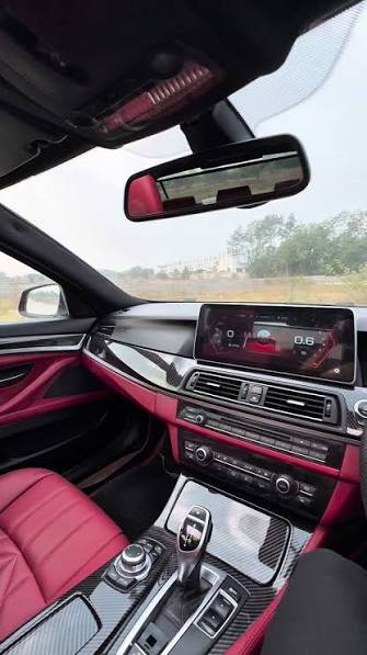 BMW cabin with custom red leather retrim and carbon fiber trim by Ignite Customs Car Decor Nashik